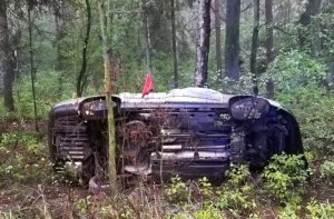 rozbity samochód koloru srebrnego w lesie