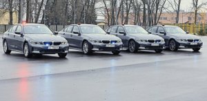 zdjęcie pokazuje cztery samochody w kolorze ciemnym ustawione obok siebie, są to nieoznakowane radiowozu maki BMW