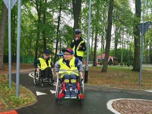 dzieci na wózkach inwalidzkich w miasteczku ruchu drogowego