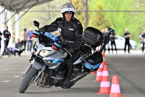 policjant w umundurowaniu na oznakowanym motocyklu